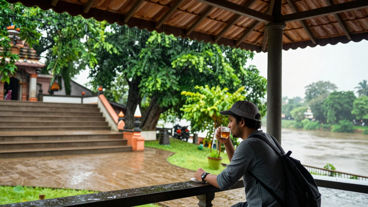 A traveler sips tea under an awning in Pondicherry during September, with lush greenery and a full river in the background, symbolizing the calm after monsoon peak.